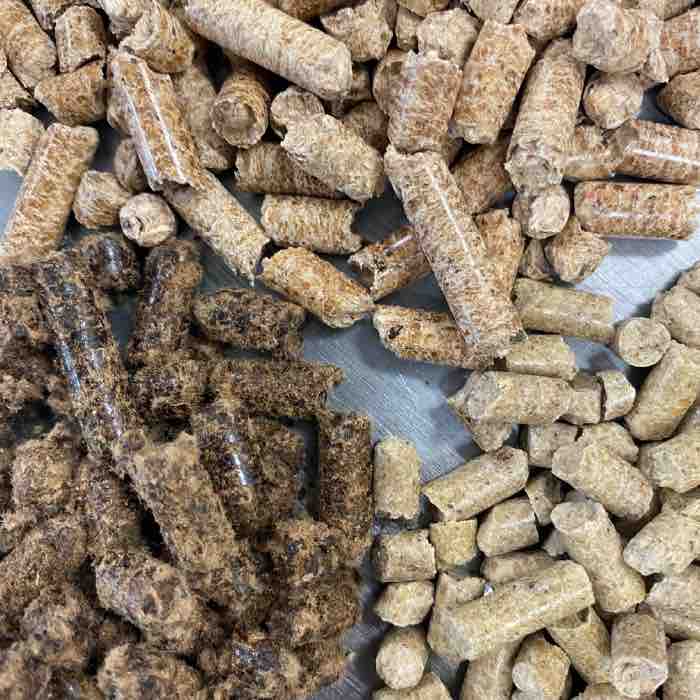 a small pile of fuel pellets and bran on a metal table